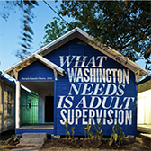 Image of blue house with quote by Barack Obama painted on i; part of Rick Lowe's Project Row Houses art installation.